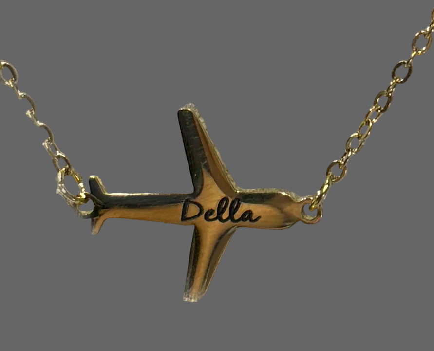 Gold airplane-shaped necklace with name engraved