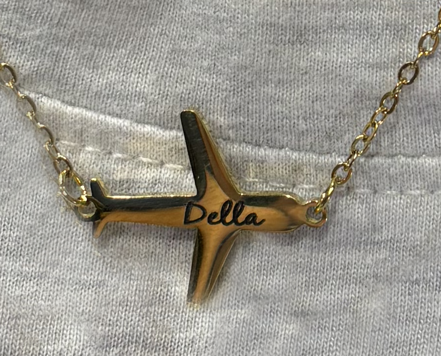 Gold airplane-shaped necklace with name engraved