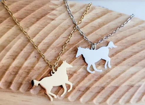 Two horse-shaped pendants on gold and silver chains engravable