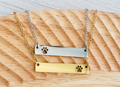 Necklace with paw print design on a horizontal bar in silver or gold